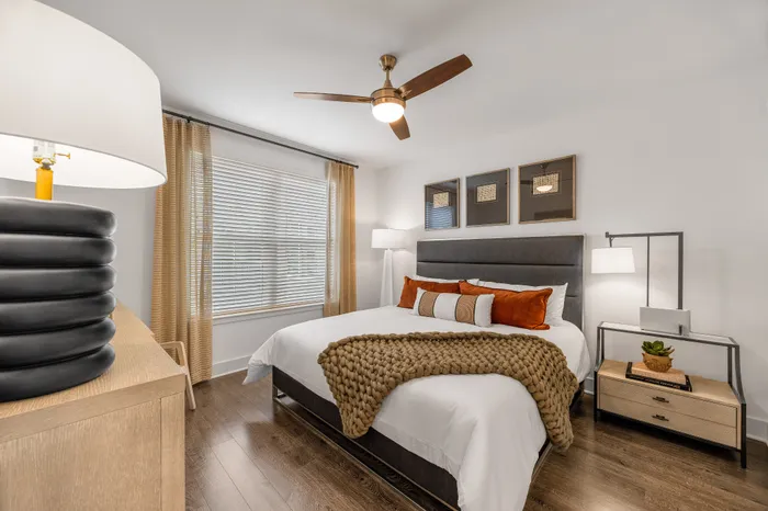Elegant bedroom featuring a modern design with a cozy bed, stylish accessories, and warm lighting.