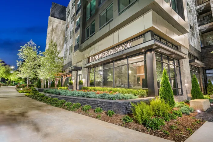 Elegant exterior of Hanover Edgewood showcasing modern design and lush landscaping in an urban setting.