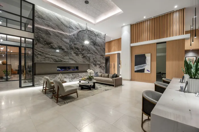 Luxurious lobby with modern marble accents, cozy seating area, stylish decor, and warm ambient lighting.