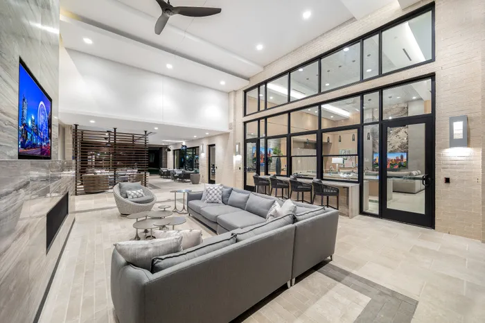 Luxurious open-concept living space featuring plush seating, sleek modern design, and ample natural light for ultimate relaxation and entertainment.