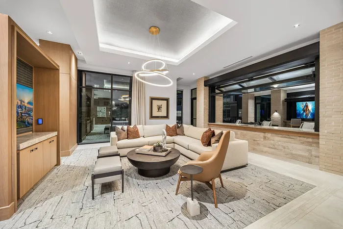 Luxurious and modern living room featuring a cozy L-shaped sofa, elegant lighting, and stylish decor.