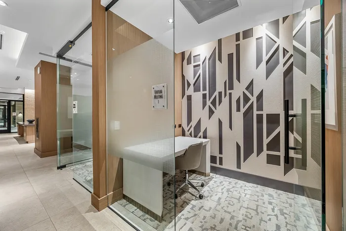 Sophisticated virtual meeting room with modern glass walls, geometric wallpaper, and elegant furnishings.