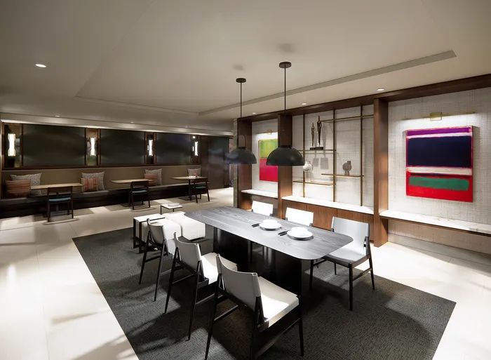 Modern dining area with sleek table, contemporary seating, and vibrant artwork, creating an inviting and stylish atmosphere.