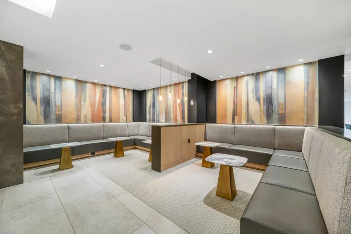 Elegant lounge area with modern seating and artistic wall decor, perfect for relaxation and social gatherings.