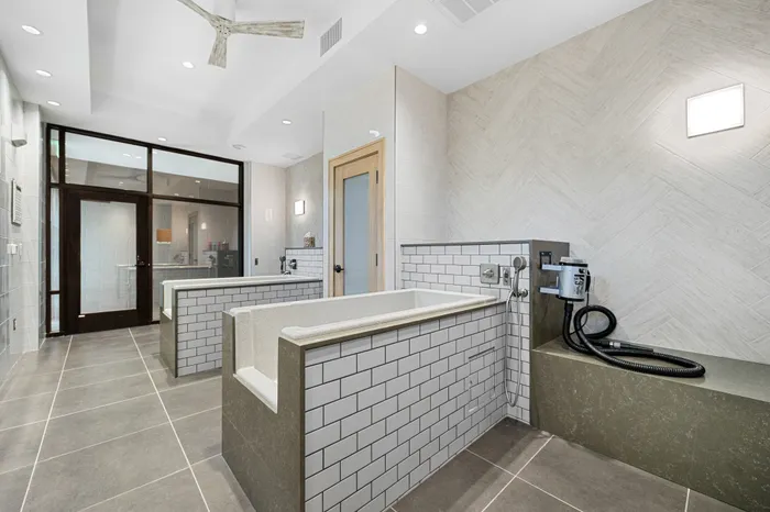 Elegant spa-like bathroom featuring modern tile design, dual soaking tubs, and sleek fixtures for ultimate relaxation.