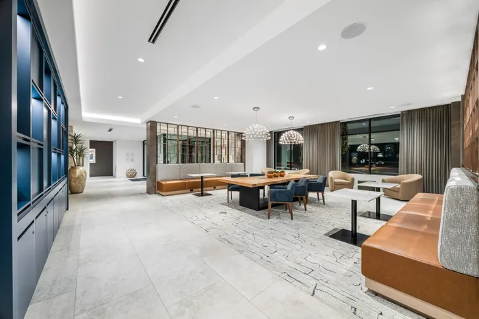 Elegant communal space with modern seating, stylish lighting, and large windows offering natural light.