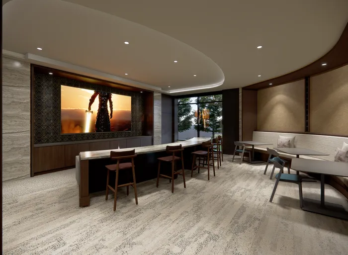 Luxurious communal lounge with modern seating, a large screen TV, elegant lighting, and floor-to-ceiling windows offering scenic views.