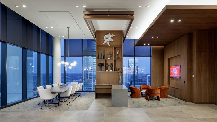 Sophisticated modern apartment interior with breathtaking floor-to-ceiling windows, elegant dining area, and cozy seating with a city view.