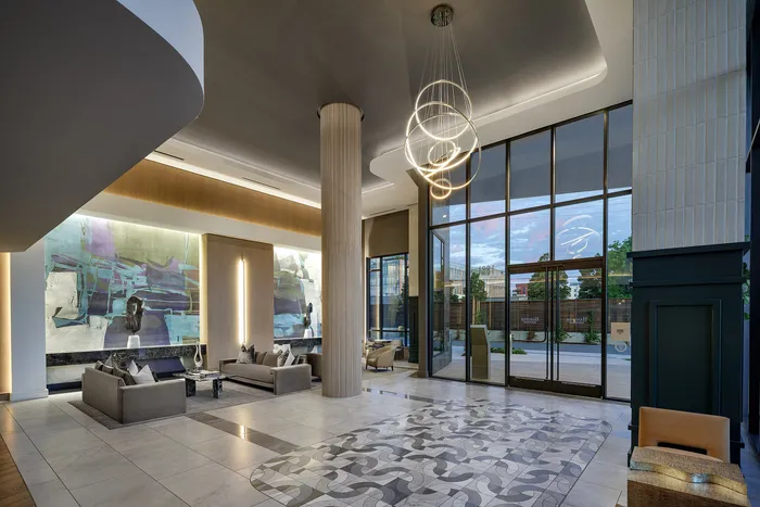 Elegant lobby with modern art and stylish lighting in a luxurious apartment building.