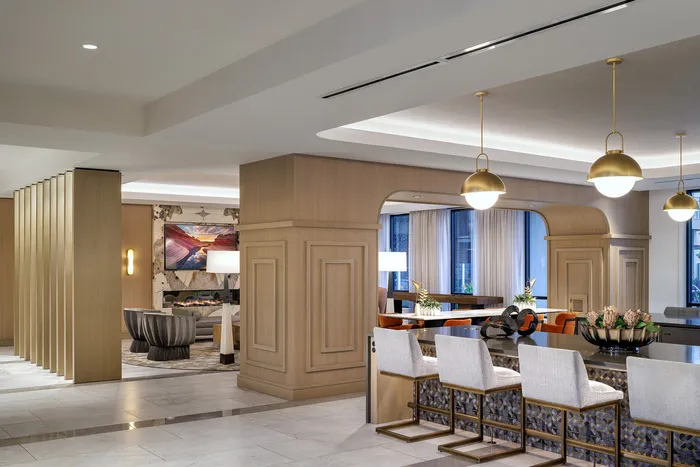 Elegant apartment interior showcasing a modern open-concept lounge and dining area with stylish lighting and chic decor.