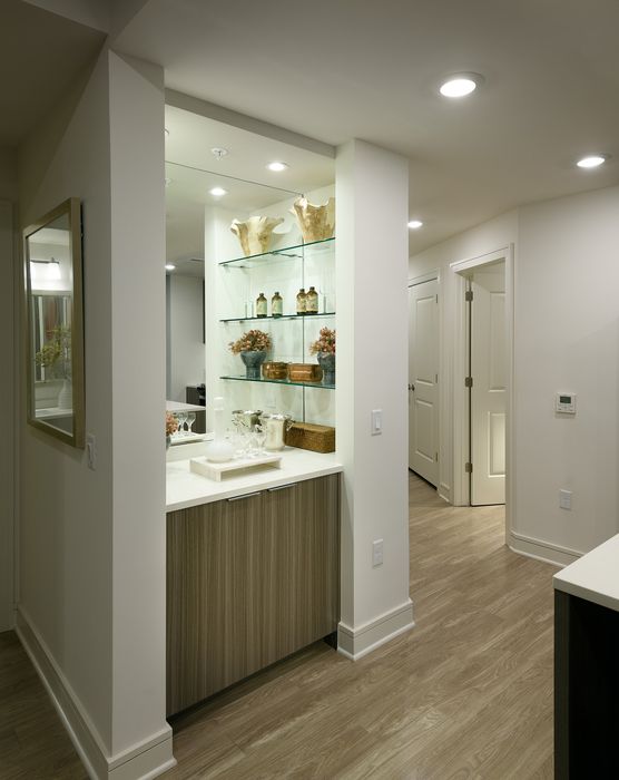 Sophisticated apartment nook with elegant shelving, stylish decor, and sleek cabinetry, perfect for modern living.