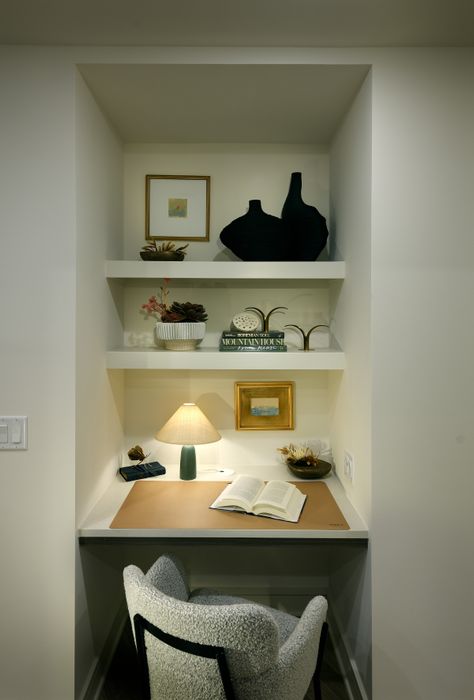 Cozy reading nook with stylish shelves, elegant decor, and warm lighting, perfect for relaxation and inspiration.