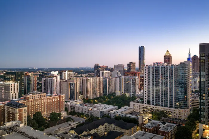 Captivating urban skyline at dusk, showcasing a vibrant mix of modern high-rises and historic architecture under a serene evening sky.