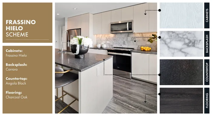 Elegant kitchen featuring Frassino Hielo cabinets, Carrara backsplash, Angola Black countertops, and Charcoal Oak flooring.