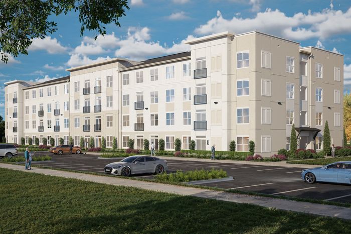 Modern apartment building with multiple floors, balconies, and a spacious parking lot in a serene neighborhood.