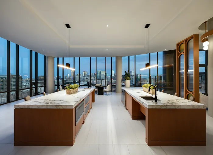 Luxurious high-rise kitchen with panoramic city views, featuring elegant marble countertops and modern pendant lighting.