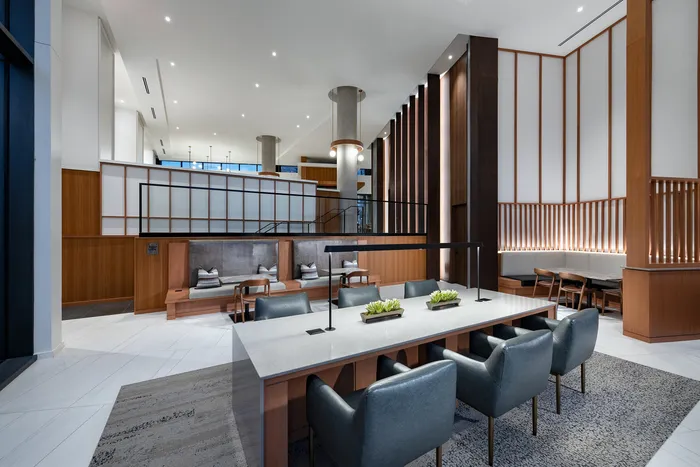 Elegant modern lobby with sleek design featuring comfortable seating, stylish lighting, and decorative accents.