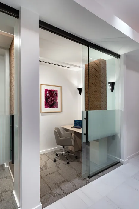 Modern study nook with a sleek desk, comfortable chair, and artistic wall decor, perfect for productivity in a stylish home.