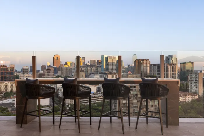 Luxurious rooftop terrace offering panoramic city skyline views with stylish seating for a perfect sunset experience.