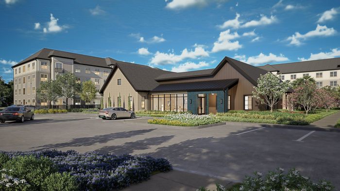 Charming residential complex with modern architecture, lush landscaping, and ample parking under a vibrant blue sky.