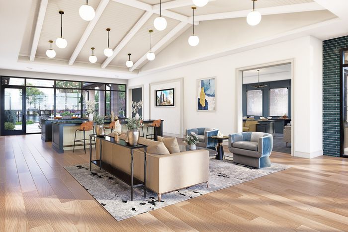 Elegant living space with vaulted ceilings, stylish furnishings, and abundant natural light overlooking a scenic patio.