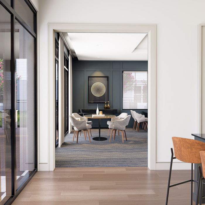 Elegant dining area with modern decor, featuring a sleek round table surrounded by plush chairs, perfect for hosting intimate gatherings.
