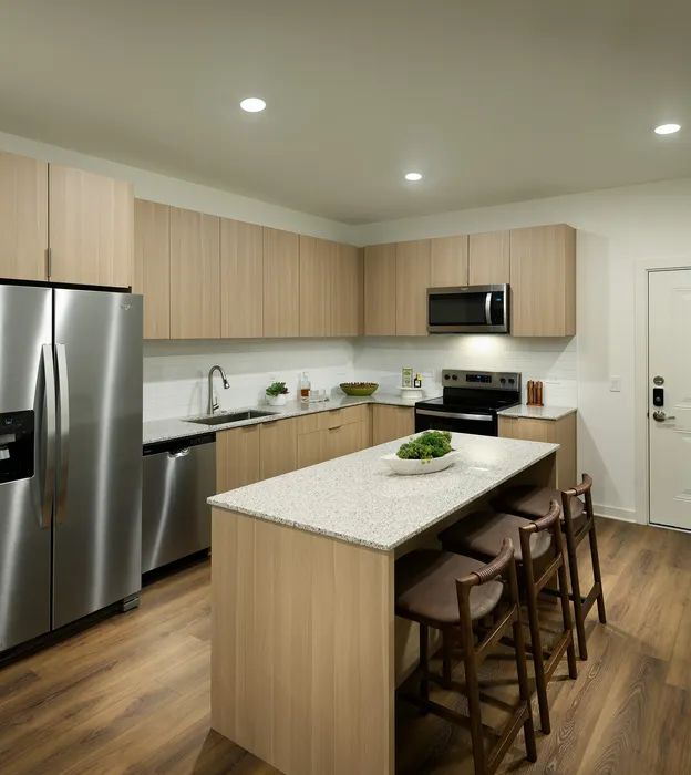 Contemporary kitchen with sleek stainless steel appliances, stylish wood cabinetry, and a chic breakfast island with seating.