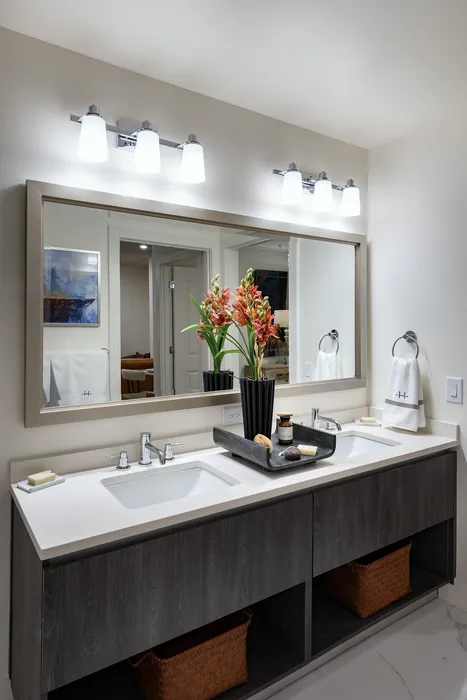 Elegantly designed bathroom with dual sinks, stylish lighting, and modern decor.