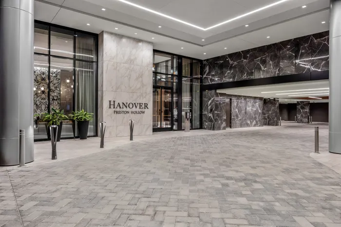 Sophisticated entrance of Hanover Preston Hollow showcasing modern architecture with sleek marble and glass accents.