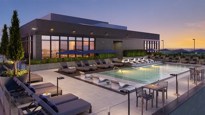 Luxurious rooftop pool area with elegant lounge chairs, stylish umbrellas, and panoramic sunset views.