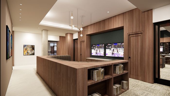 Chic modern lobby with sleek wood paneling, elegant lighting, and flat-screen TVs creating a luxurious ambiance.