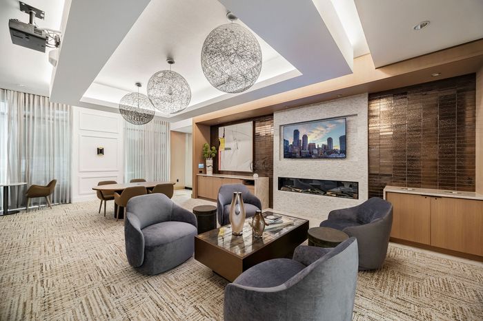 Luxurious modern lounge with plush seating, elegant decor, and ambient lighting, perfect for relaxation and entertainment.