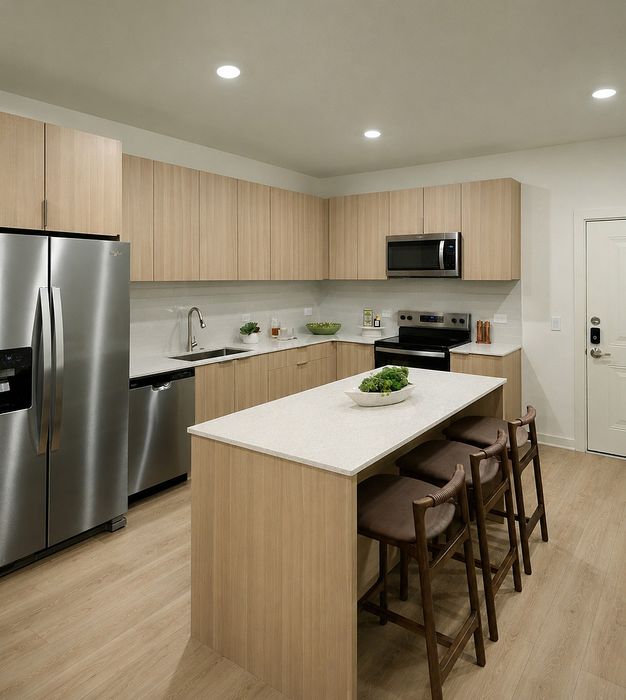 Modern kitchen with sleek wooden cabinetry, stainless steel appliances, and a stylish central island.