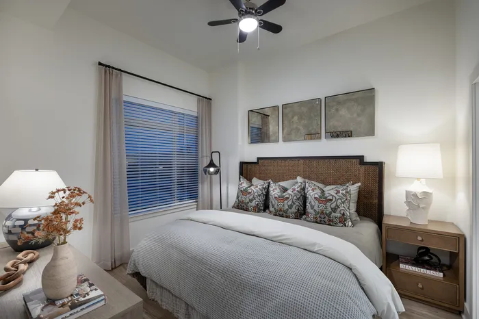 Charming bedroom with cozy bedding, warm lighting, and elegant decor for a serene ambiance.