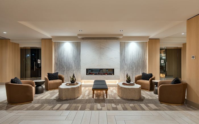 Luxurious lounge area with elegant seating, stylish marble fireplace, and ambient lighting creating a cozy atmosphere.