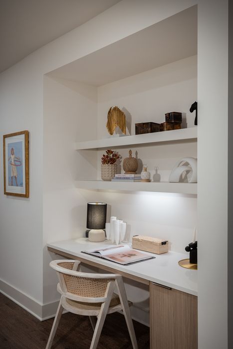 Elegant home office nook with built-in shelves, stylish decor, and a sleek desk setup.