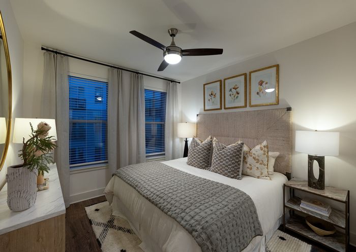 Elegant bedroom with a cozy king-sized bed, stylish decor, and ambient lighting creating a serene atmosphere.