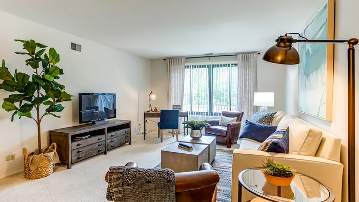 The pleasant living room creates a warm and comfortable atmosphere perfect for daily relaxation.  |  International Village Lombard | Apartments in Lombard