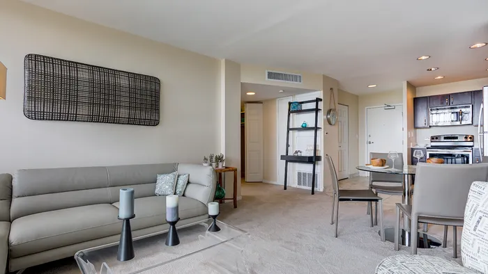 The pleasant living room creates a warm and comfortable atmosphere perfect for daily relaxation. | The Glen View | Apartments in Glenview