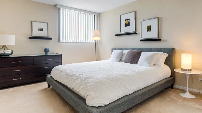 This elegant primary bedroom features sophisticated design elements and comfortable proportions for restful nights. | The Glen View | The Glen View Apartments