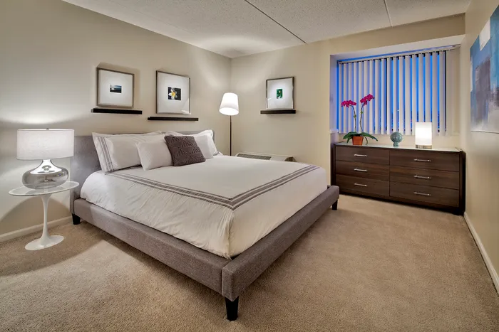 This primary bedroom with attached bath offers convenient privacy and comfort with ensuite bathroom access. | The Glen View | Apartments in Glenview