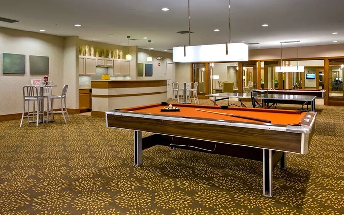 Demonstrate your steady hand on our shuffleboard table in game room where precision and strategy combine for engaging recreational play. | International Village Schaumburg | International Village Schaumburg Apartments