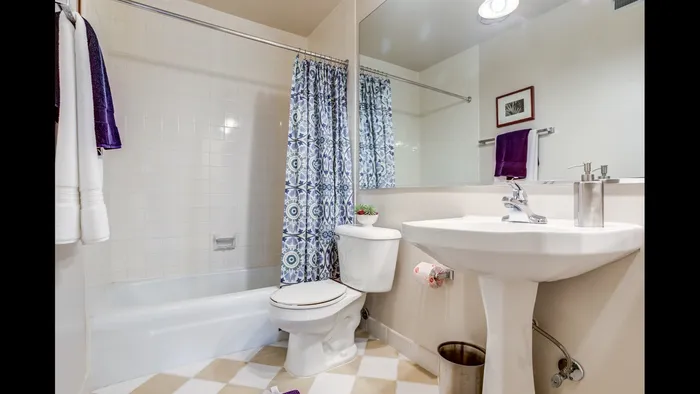 This primary bedroom with attached bath offers convenient privacy and comfort with ensuite bathroom access. | International Village Schaumburg | Apartments in Schaumburg