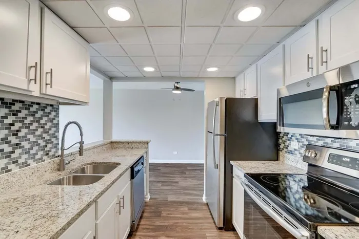 The modern kitchen offers streamlined design with efficient workflow and attractive finishes throughout.  | The Views Of Naperville | The Views Of Naperville Apartments