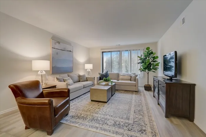 This spacious living room offers plenty of room for relaxation and entertaining with flexible layout options.  |  International Village Lombard |