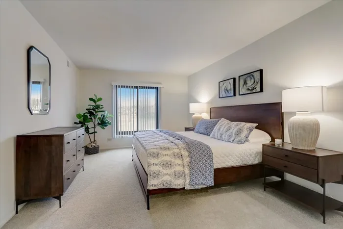 This elegant primary bedroom features sophisticated design elements and comfortable proportions for restful nights.  | International Village Schaumburg | International Village Schaumburg Apartments