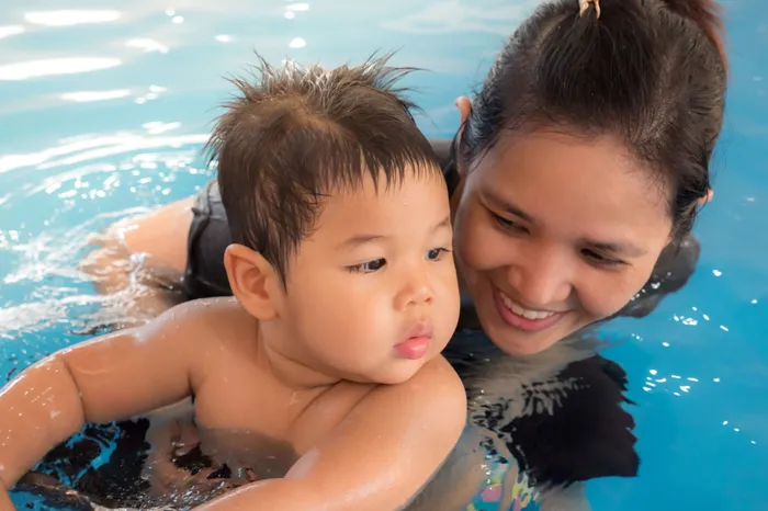 Enhance your pool experience with our swim-up bar creating a perfect gathering spot and social hub in the swimming area.  | International Village Schaumburg | International Village Schaumburg Apartments