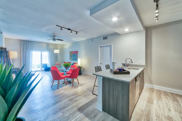 The Reserve at Vero Beach, interior, open concept, kitchen, dining room, large sliding glass doors, ceiling fan, wood floors
