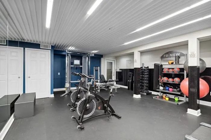 fitness center with cardio and weight machines and free weights