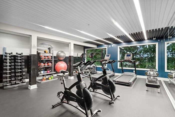 fitness center with cardio and weight machines and free weights
